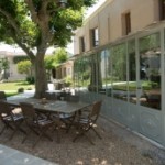 tables under plane trees on the verandah