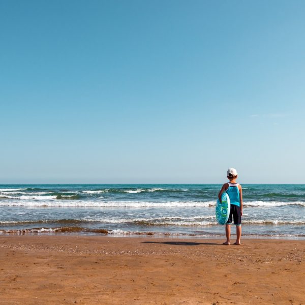 A child with a lifebuoy on the seashore